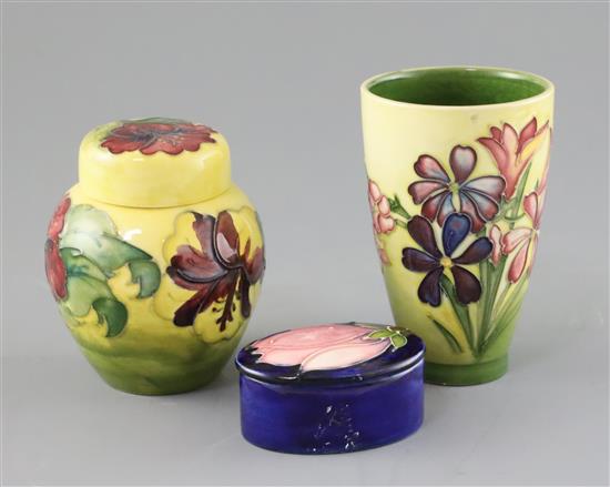 A Moorcroft spring flowers vase, a hibiscus jar and cover and a magnolia trinket box and cover, 1970s, 7cm - 12cm